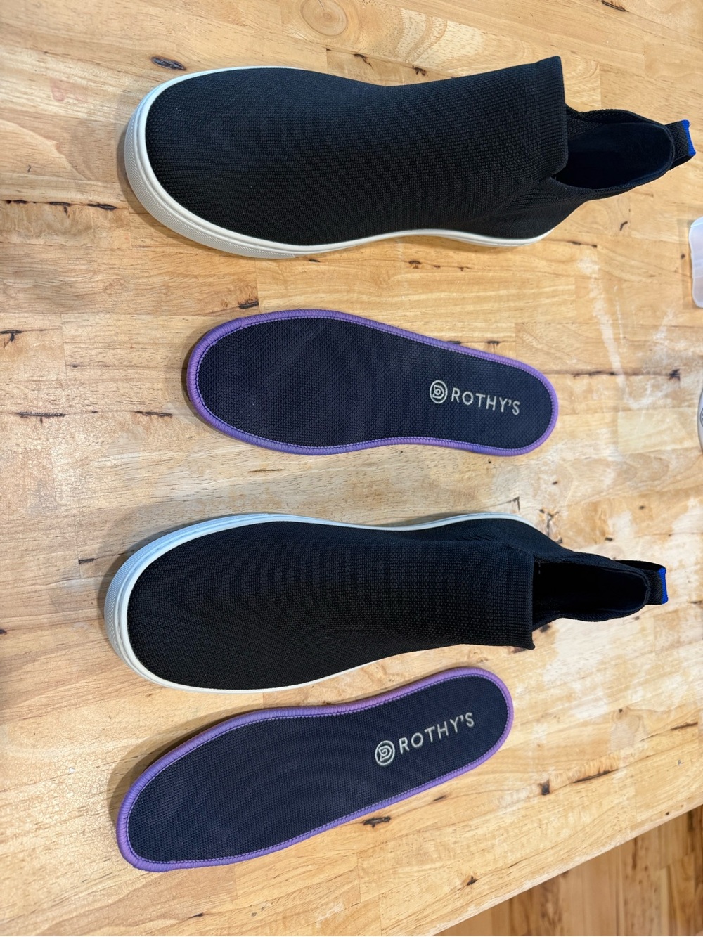 Rothy's Black Slip-On Knit Sneakers with Purple-Trim Insoles